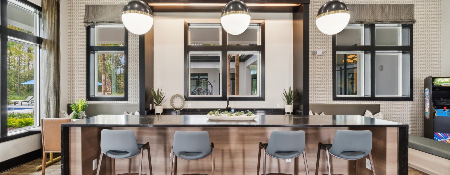 a kitchen with a bar and chairs