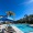 pool with lounge chairs and palm trees