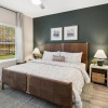 a bedroom with a bed and a fan